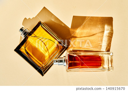 Perfume bottles creating elegant shadows and golden light Perfume bottles creating elegant shadows and golden light 140915670