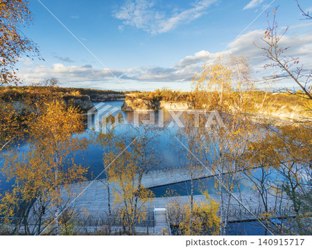Zakrzowek quarry lake with autumn trees and floating platforms Zakrzowek quarry lake with autumn trees and floating platforms 140915717