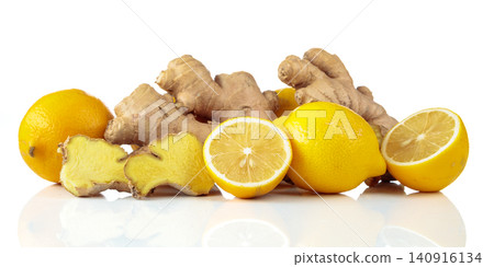 Fresh lemons and ginger roots isolated on a white background. Fresh lemons and ginger roots isolated on a white background. 140916134