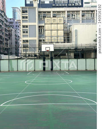 Urban basketball court with buildings in the background on a clear day 140916192