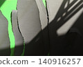 Torn paper pieces revealing green screen with shadows 140916257