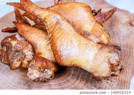 Chicken wings are placed neatly on wooden board in kitchen they look cooked ready to eat for meal. Chicken wings are placed neatly on wooden board in kitchen they look cooked ready to eat for meal. 140916314