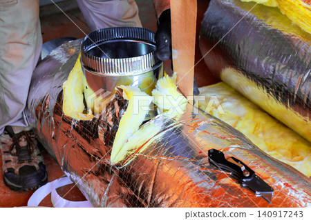 Worker are seen working on HVAC duct installation in home tools materials are spread around area. Worker are seen working on HVAC duct installation in home tools materials are spread around area. 140917243