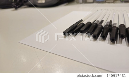 Stationery Set: Black Pens Lined Up on Blank Paper Stationery Set: Black Pens Lined Up on Blank Paper 140917481