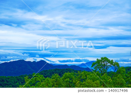 From Mt. Asuwa, one can see the mountain range to the south, towards Mt. Hachiman, with its fresh green leaves and new growth, and a sea of clouds. 140917496