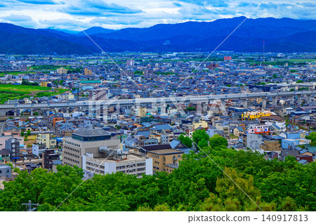 View from Mt. Asuwa: The Hokuriku Shinkansen passing by, and the cityscape towards the Fukui Chamber of Commerce and Industry. View from Mt. Asuwa: The Hokuriku Shinkansen passing by, and the cityscape towards the Fukui Chamber of Commerce and Industry. 140917813