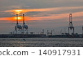 Sunset, the sea, and gantry cranes 140917931