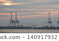 Sunset, the sea, and gantry cranes 140917932