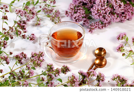 Oregano infusion in glasses with a bouquet of flowers, medicinal herbal tea, alternative folk medicine concept, green pharmacy advertisement, a collection of beneficial herbs for folk medicine, Oregano infusion in glasses with a bouquet of flowers, medicinal herbal tea, alternative folk medicine concept, green pharmacy advertisement, a collection of beneficial herbs for folk medicine, 140918021