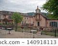 Pink building and waterside cafe terrace 140918113