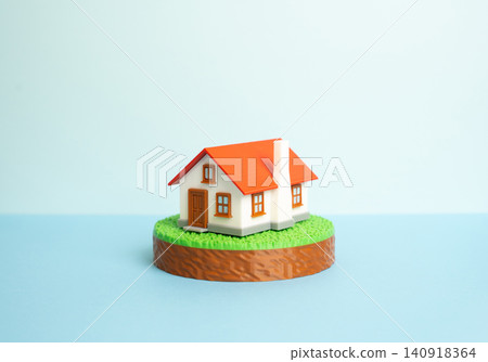 A suburban house on a plot of land. Figurines. Housing, buying and renting. Building a dream home. The real estate market. A suburban house on a plot of land. Figurines. Housing, buying and renting. Building a dream home. The real estate market. 140918364