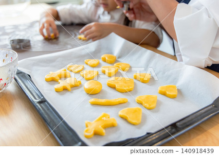 A girl and her mom making cookies 140918439