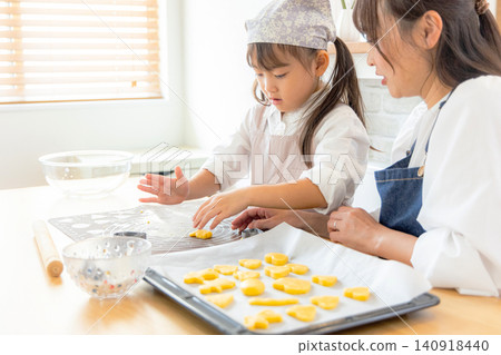 A girl and her mom making cookies 140918440