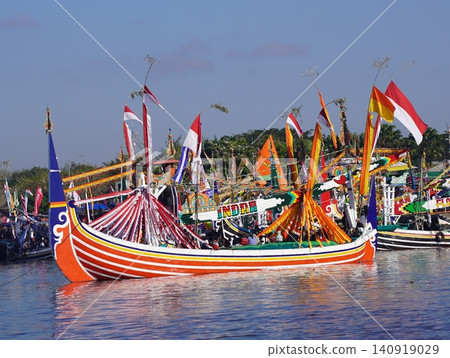 MUNCAR, INDONESIA - JULY 1, 2026: Traditional decorated fishing boats participate in the annual Petik Laut ceremony, a cultural sea offering and thanksgiving event held by the local fishermen communit 140919029