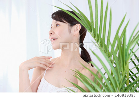 A woman with a beauty image touches her neck with a look of rapture. A woman with a beauty image touches her neck with a look of rapture. 140919385