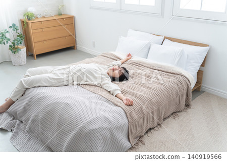 Young woman sleeping in bed Young woman sleeping in bed 140919566