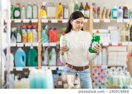 Female buyer choosing dishwashing detergents Female buyer choosing dishwashing detergents 140919868