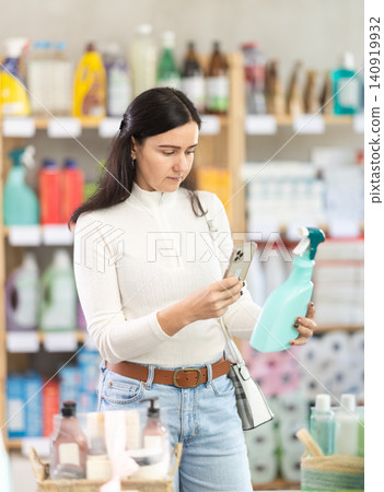 customer scans the barcode of a package with spray in a supermarket customer scans the barcode of a package with spray in a supermarket 140919932