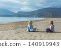 Boy and girl sit in yoga pose and relaxin on sand Iztuzu Beach known as Turtle beach near Dalyan, on Turkey coast of mediterranean sea. Travel moments, kids active lifestyle on family holidays. 140919943