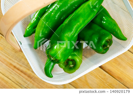 Green peppers on wooden table, cooking ingredients Green peppers on wooden table, cooking ingredients 140920179