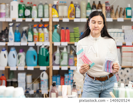 Woman choosing hair shaving machines in supermarket Woman choosing hair shaving machines in supermarket 140920524