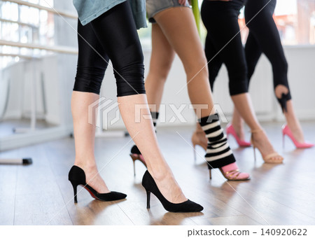 Female legs in sportswear and high heels performing graceful walk of stiletto dance Female legs in sportswear and high heels performing graceful walk of stiletto dance 140920622