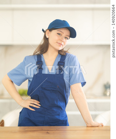 Young woman worker at table in kitchen 140920664
