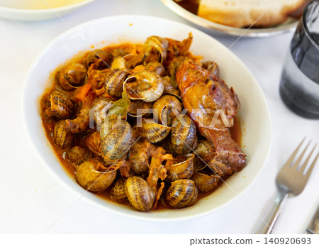 Stewed snails with rabbit meat and sausages Stewed snails with rabbit meat and sausages 140920693