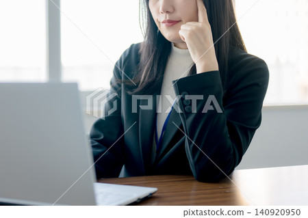 Businesswomen who think in front of their computers Businesswomen who think in front of their computers 140920950