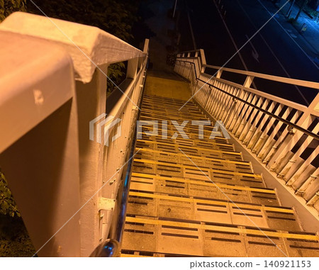 A striking composition of a pedestrian overpass staircase, a stock photo that depicts urban infrastructure. A striking composition of a pedestrian overpass staircase, a stock photo that depicts urban infrastructure. 140921153