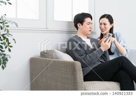 Young men and women searching on their smartphones: Lifestyle image Young men and women searching on their smartphones: Lifestyle image 140921383