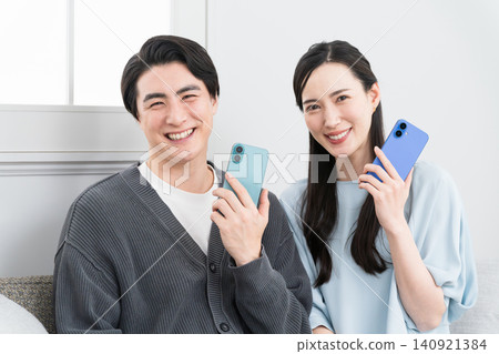 Young men and women searching on their smartphones: Lifestyle image Young men and women searching on their smartphones: Lifestyle image 140921384