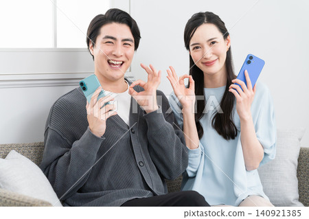 Young men and women searching on their smartphones: Lifestyle image Young men and women searching on their smartphones: Lifestyle image 140921385