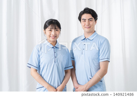 Smiling male and female care staff Smiling male and female care staff 140921486