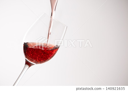 Red wine poured into a glass 140921635