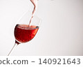 Red wine poured into a glass 140921643