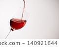 Red wine poured into a glass 140921644
