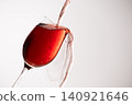 Red wine poured into a glass 140921646