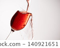 Red wine poured into a glass 140921651