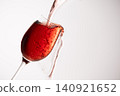 Red wine poured into a glass 140921652