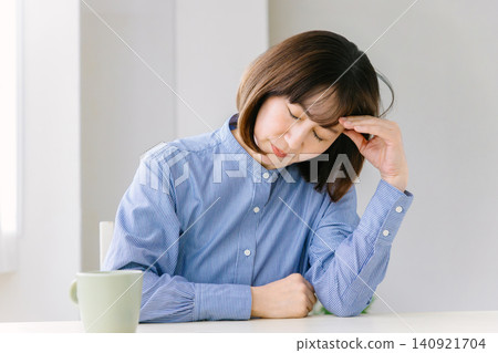 A middle-aged woman with a pained expression. A middle-aged woman with a pained expression. 140921704