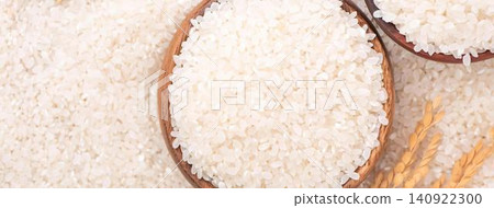 Baskets of white rice on a rustic surface with wheat 140922300