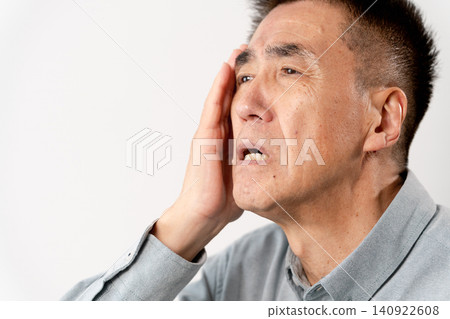 A senior man in casual clothes standing – a lifestyle image. A senior man in casual clothes standing – a lifestyle image. 140922608