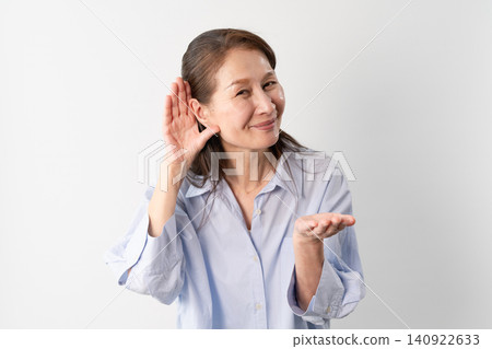 A senior woman in casual clothes standing – a lifestyle image. A senior woman in casual clothes standing – a lifestyle image. 140922633