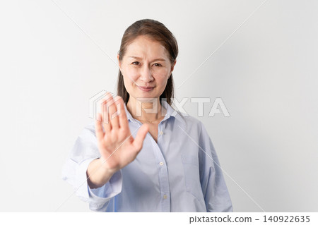 A senior woman in casual clothes standing – a lifestyle image. A senior woman in casual clothes standing – a lifestyle image. 140922635