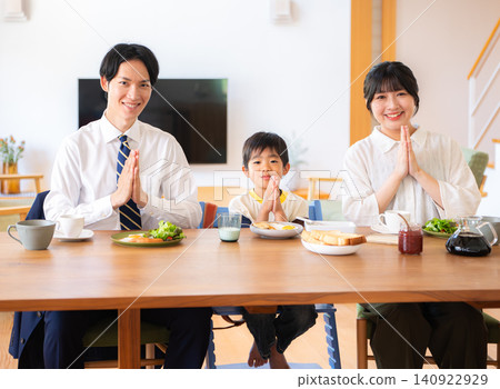 A family of three eating breakfast before going to work or school. A family of three eating breakfast before going to work or school. 140922929