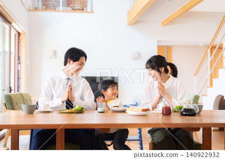 A family of three eating breakfast before going to work or school. A family of three eating breakfast before going to work or school. 140922932
