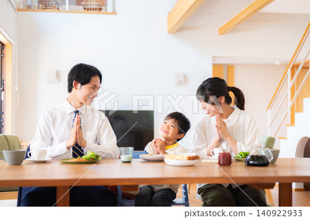 A family of three eating breakfast before going to work or school. A family of three eating breakfast before going to work or school. 140922933