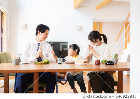 A family of three eating breakfast before going to work or school. A family of three eating breakfast before going to work or school. 140922935