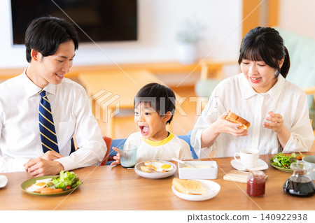 A family of three eating breakfast before going to work or school. A family of three eating breakfast before going to work or school. 140922938